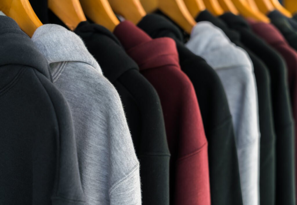 Row of Fashionable clothing on hangers .